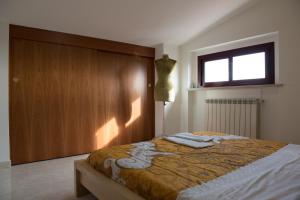 a bedroom with a bed with a wooden wall at Via del Mare in Lanciano