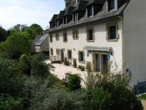 a large white house with a gambrel roof at Logis Hotel De La Corniche in Brest