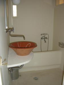 a bathroom with a wooden bowl sink on a counter at The Best Town View in Mýkonos City