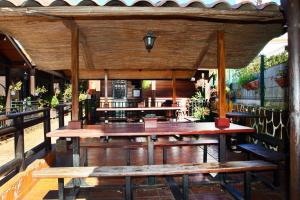 a pavilion with wooden tables and benches on a patio at Cabañas Valle Verde in Moya