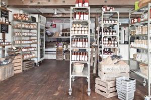 a store with shelves filled with lots of products at Siggesta Gård in Värmdö