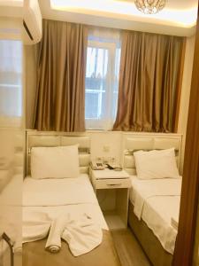 Postel nebo postele na pokoji v ubytování ARINÇ HOTEL