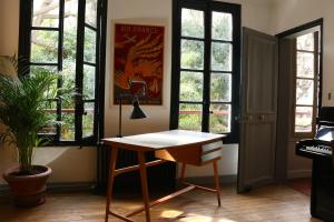 a desk in a room with windows and a keyboard at Le 66 in Paris