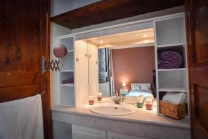 a bathroom with a sink and a mirror at Domaine de La Ramée in Trévières +29 photos