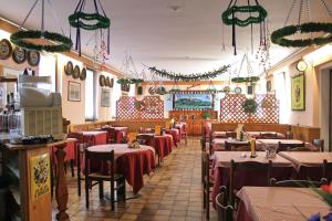 a dining room with tables and chairs and christmas decorations at Al Ponte della Vittoria in Belluno