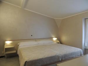 Un ou plusieurs lits dans un hébergement de l'établissement Hotel Doria
