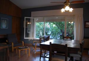 a dining room with a table and chairs and a window at Casa Monty in Mina Clavero