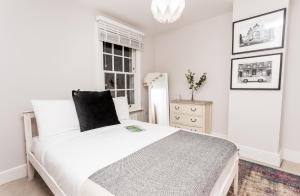 Habitación blanca con cama y ventana en The Modern Classic - Contemporary & Elegant 3BDR Home en Cambridge