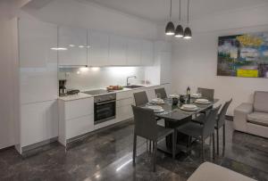 a kitchen and dining room with a table and chairs at Unique Apartment close to Acropolis by GHH in Athens