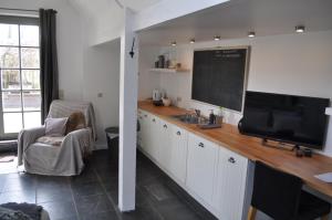 a classroom with a chalkboard and a desk with a tv at B&B L'Eau Claire in La Hulpe