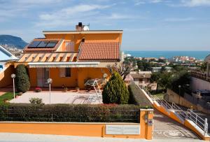 a yellow house with a staircase leading up to it at La Perla Del Conero Affittacamere in Numana
