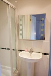 a bathroom with a sink and a mirror at Bod Gwynedd Bed and Breakfast in Betws-y-coed