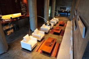 a room with a table, chairs, and a sink at Design Suites Salta in Salta