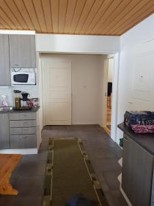 a kitchen with a door in the middle of a room at Järvitalo in Soini