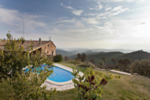 a house with a swimming pool next to a building at CONFORTABLE CASA RURAL (1062) in La Baronia de Rialb