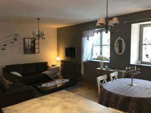 a living room with a couch and a table at Gite Des 3 Chateaux in Ribeauvillé