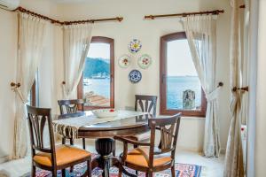 a dining room with a table and chairs and a window at Two Stone Homes Metis in Marmaris