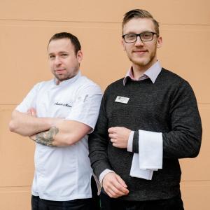 two men standing next to each other with their arms crossed at Hotel Ostrov in Tisá +37 photos