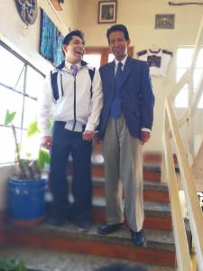 two men in suits standing on the stairs at Hotel Chalet in Chichicastenango