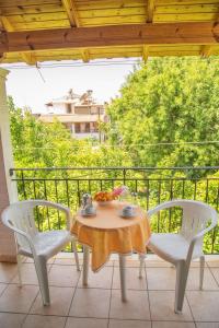 a table and two chairs on a balcony at Villa Rebecca in Agios Gordios