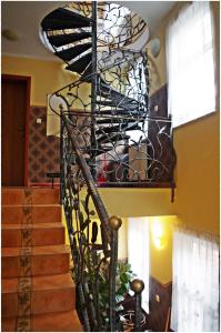 a spiral staircase in a home with a spiralsteel railing at Willa Secesja in Łeba