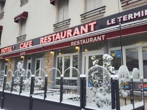 a restaurant with snow on the front of it at Terminus Fontainebleau Avon in Avon