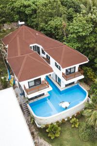 an aerial view of a house with a swimming pool at The Whitehouse by the Sea in Panglao