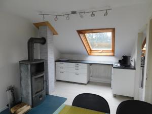a kitchen with a stove and a table in a room at Denkys-Ferienwohnung in Maulburg