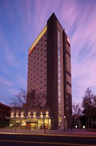 a large building with a clock on the side of it at ibis Santiago Providencia in Santiago