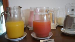 two glass containers of different colored drinks on a table at Palm Beach Plaza Hotel in Montevideo