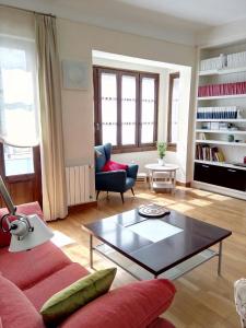 a living room with a red couch and a coffee table at La Casa Azul Almería in Almería