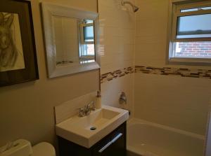a bathroom with a sink and a bath tub at Elcho's ExplOre Ottawa #3 in Ottawa +26 photos