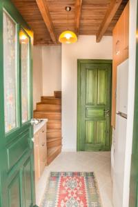 a bathroom with a green door and a rug at Two Stone Homes Asteria in Marmaris