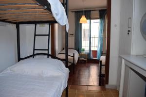 a bedroom with a bunk bed with a white bedspread at Sandy Hotel in Rome