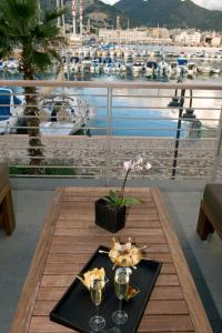 a table with a plate of food and glasses on it at Marina Place Resort in Genoa