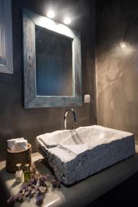 a bathroom with a sink and a mirror at Elia Horizon Mykonos in Elia Beach
