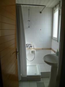 a bathroom with a shower and a sink at Datacom Guest House in Nicosia