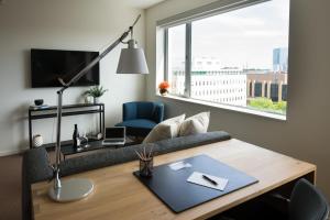 a living room with a couch and a table at The Study at University City, Study Hotels in Philadelphia