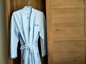 a blue robe is hanging on a door at The Study at University City, Study Hotels in Philadelphia