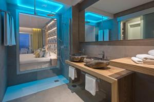 a bathroom with a sink and a large mirror at Hotel Atlantic Mirage Suites & SPA - ADULTS ONLY in Puerto de la Cruz