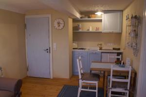 a kitchen and dining room with a table and chairs at Landhaus Grinnerhof in Mehlingen