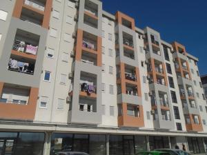a tall apartment building with balconies on it at Fantastic brand new apartment in Podgorica