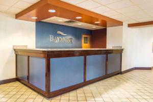 a bar in a room with a baymont sign on the wall at Baymont by Wyndham Cincinnati Sharonville in Sharonville