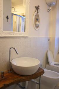 a bathroom with a sink and a toilet at Casa Sofì in Tolentino