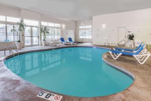 - une grande piscine d'eau bleue dans une chambre d'hôtel dans l'établissement Baymont by Wyndham Waterford/Burlington WI, à Waterford