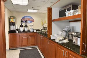 a kitchen with a counter with alcohol bottles on it at Baymont by Wyndham Oklahoma City Airport in Oklahoma City