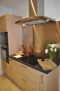 a kitchen with a black counter top at Villa farniente in Le Lavandou