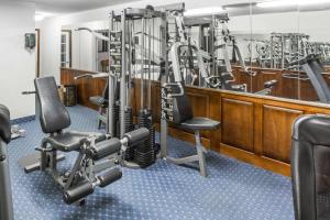 a gym with treadmills and weights at Baymont by Wyndham Greensboro/Coliseum in Greensboro