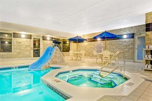 a pool with a slide in a hotel room at Baymont by Wyndham Wahpeton in Wahpeton