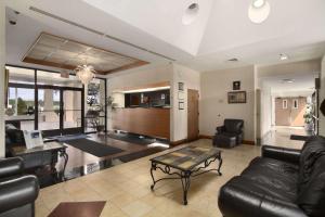 a living room with a couch and a table at Inn & Suites at George Fort Gregg-Adams in Prince George